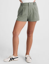 green shorts with an elastic waistband,  front zipper, button, and belt loops.